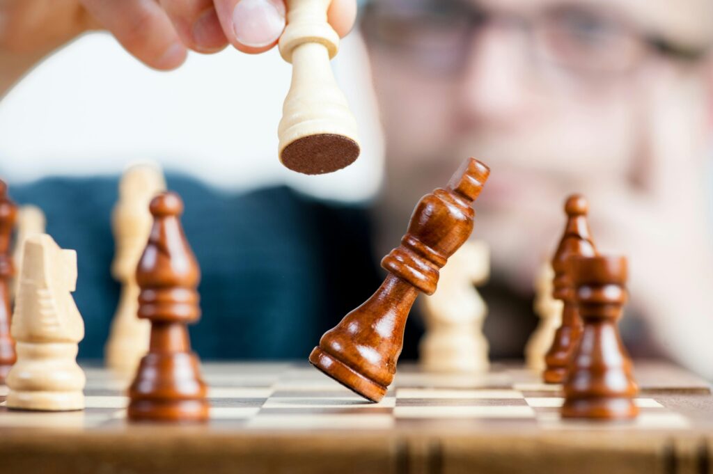 Close-up of a chess game with a focused player, emphasizing strategy and competition.